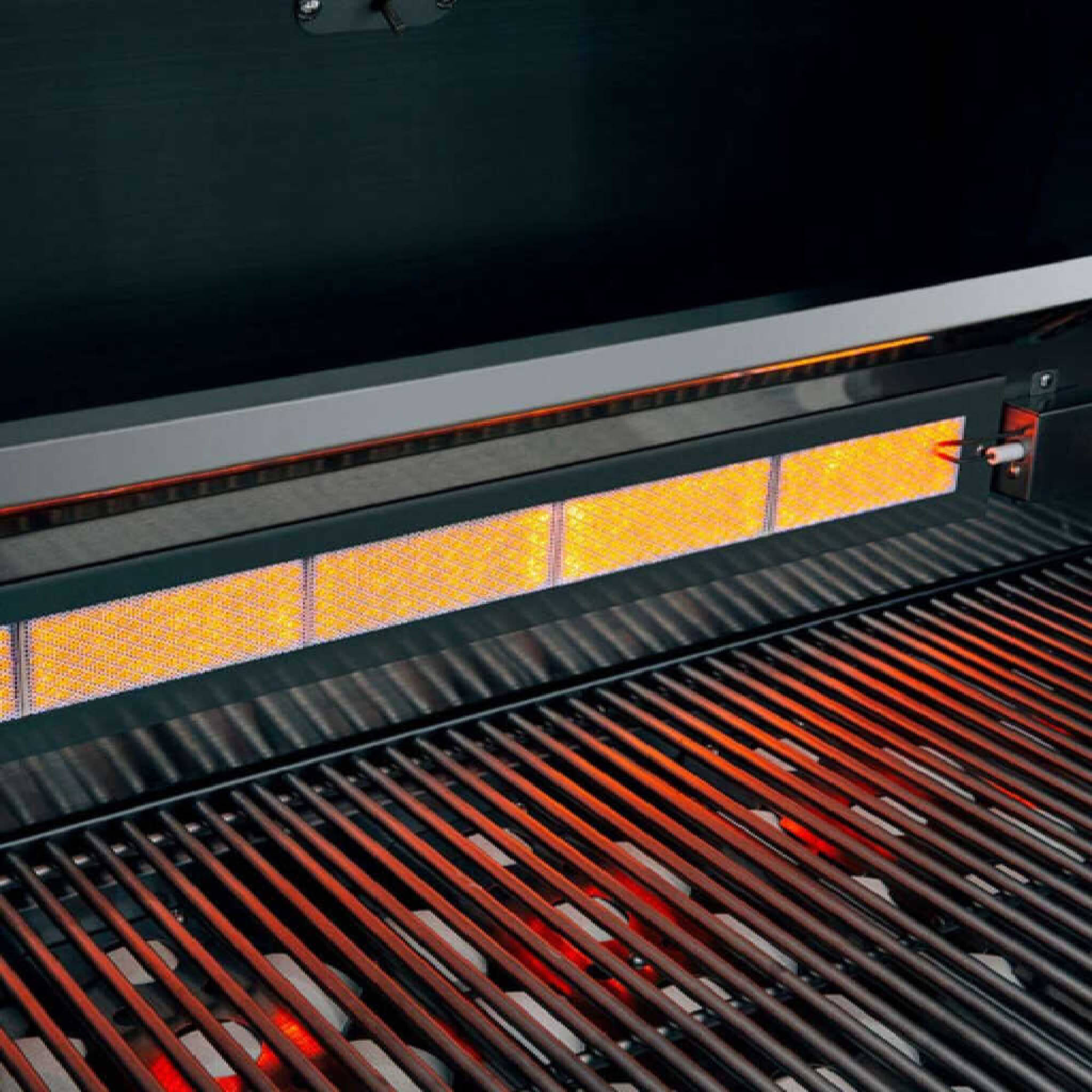 Close-up of a hot grill with glowing coals and red-hot grates.