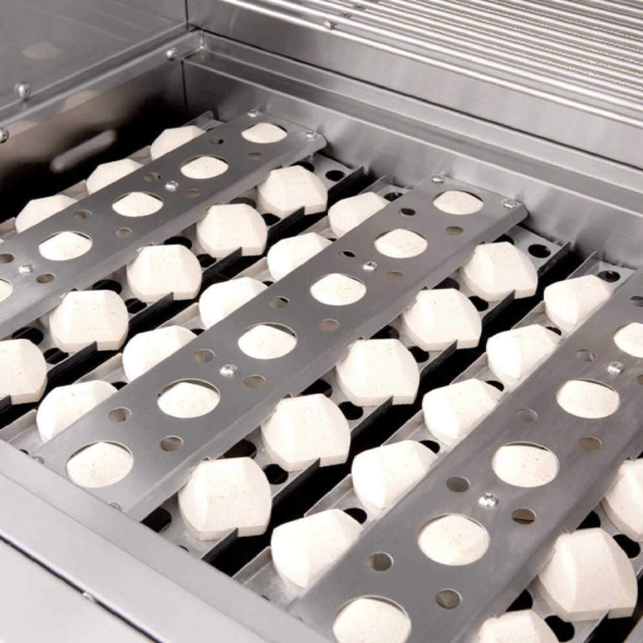 Metal trays with white spherical objects on a metallic surface
