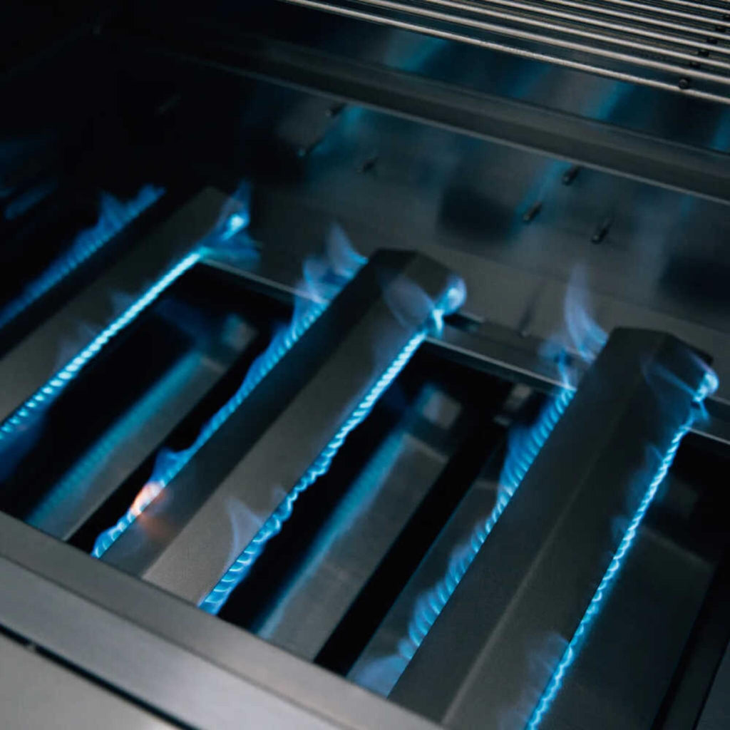 Close-up of a gas stove burner with blue flames