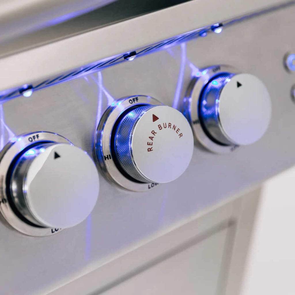 Control knobs on a stove with blue LED lights