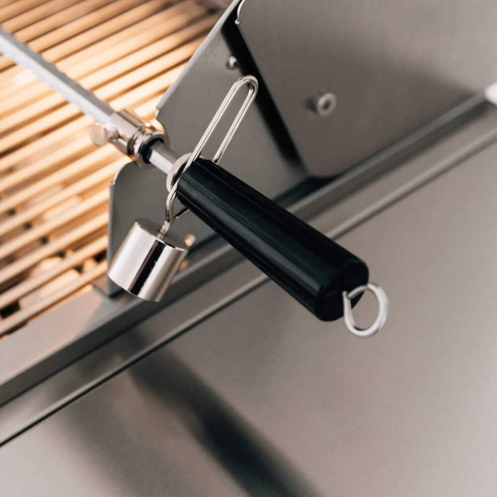 Close-up of a grill lid lifter with a black handle and metal components on a grill.