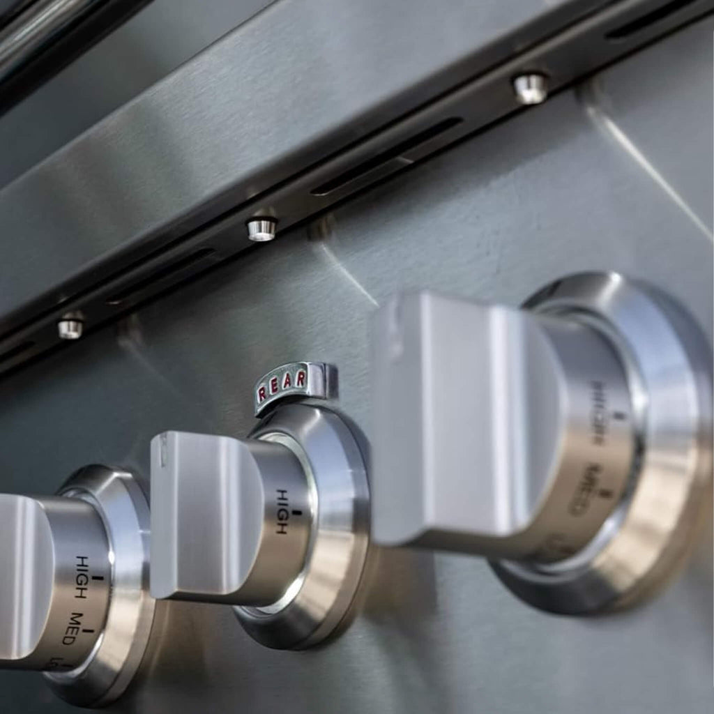 Close-up of metallic control knobs on a kitchen appliance