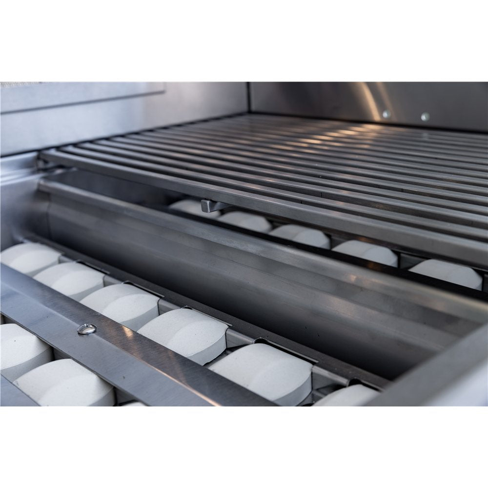 Close-up of a grill with a lid open, showing a metal grate and ceramic briquettes.
