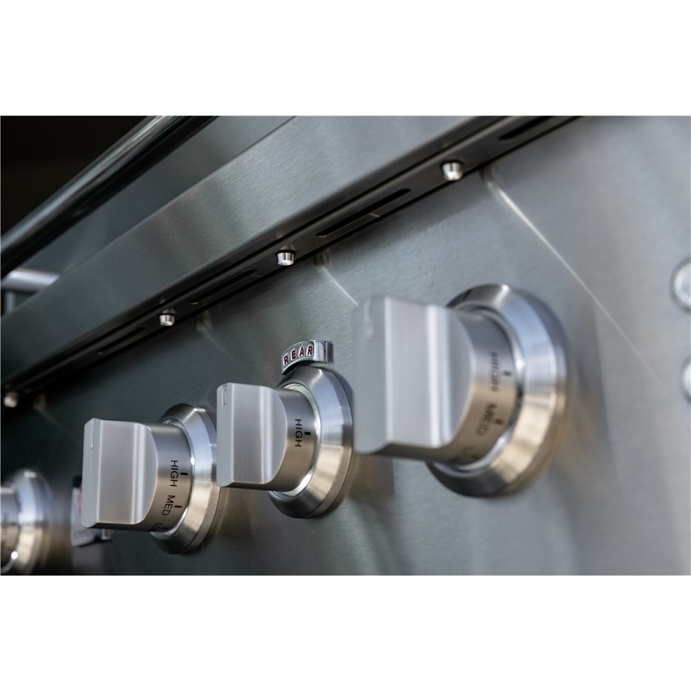 Close-up of stainless steel gas grill controls with 'Sear' and 'Grill' labels.